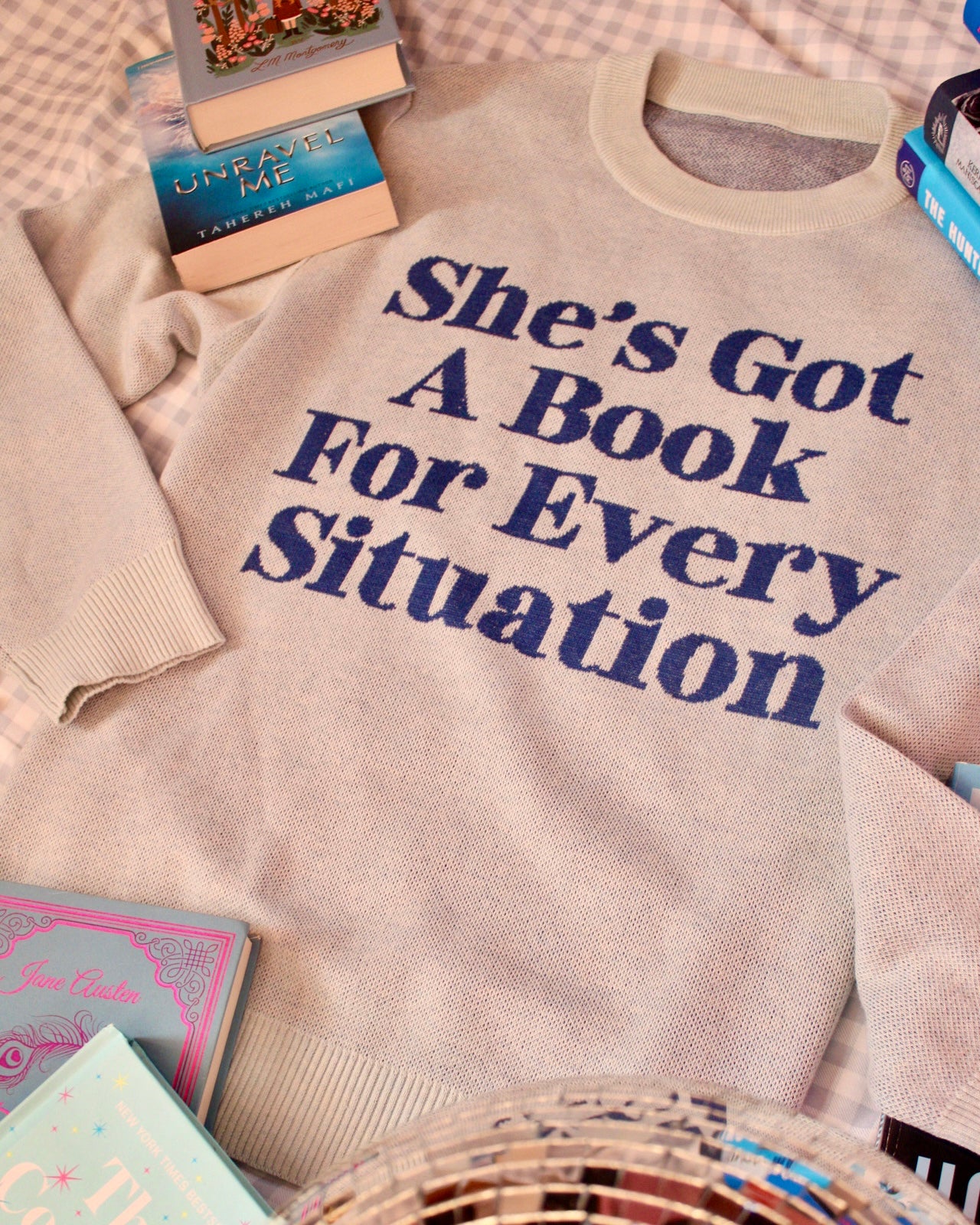 SHE'S GOT A BOOK FOR EVERY SITUATION KNIT SWEATER