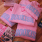 LIGHT BLUE BOOKISH GINGHAM APPLIQUÉ CREWNECK